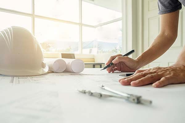 Home renovation engineer assessing a remodeling project