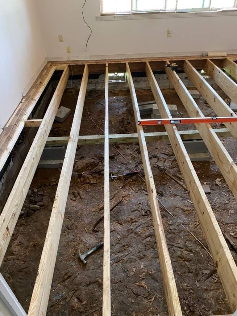 Floor joist and structural home repair work with floor installation then carpet installation